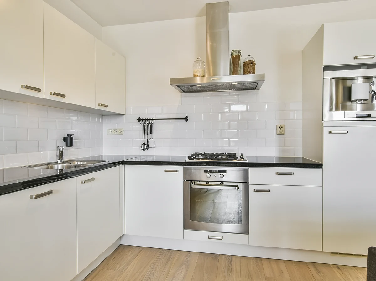 Professional matte off-white flat-panel kitchen cabinets and a white subway tile backsplash by ASC Painting Corp.